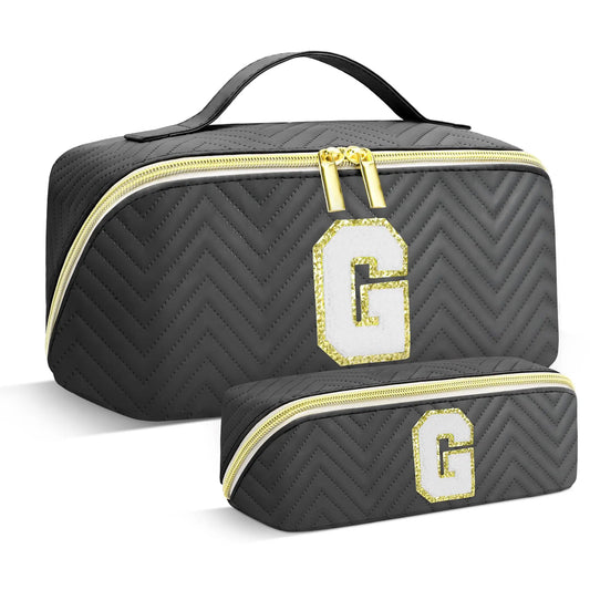 Black chevron-patterned cosmetic bag with gold accents and letter 'G' on a white background
