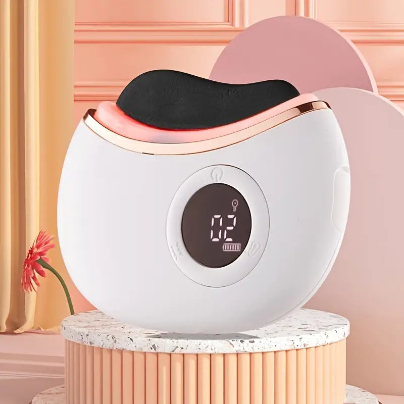 White electronic gua sha device with digital display on a decorative stand against a pink background