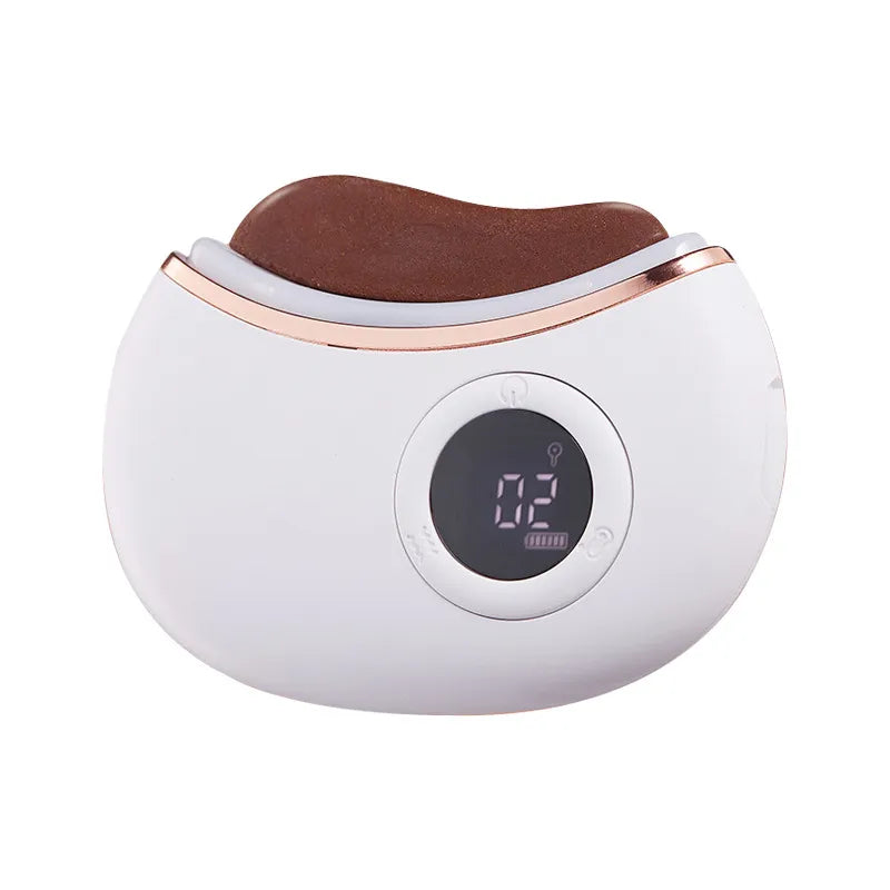 White and rose gold electronic device with red stone on a white background