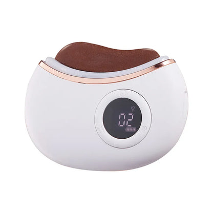 White and rose gold electronic device with red stone on a white background
