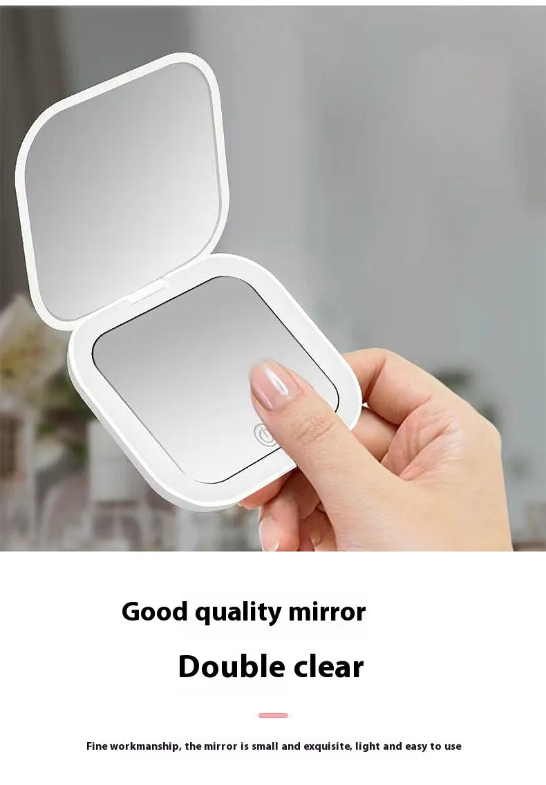 Hand holding a small, white, square mirror with a light on a blurred background