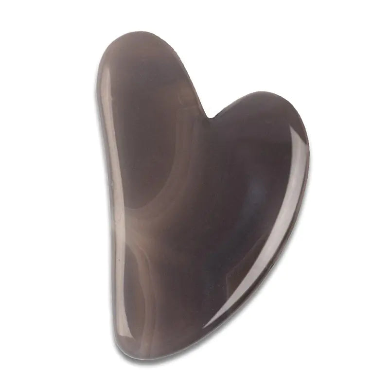Heart-shaped brown stone on a white background
