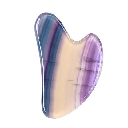 Multicolored stone with purple and blue patterns on a white background