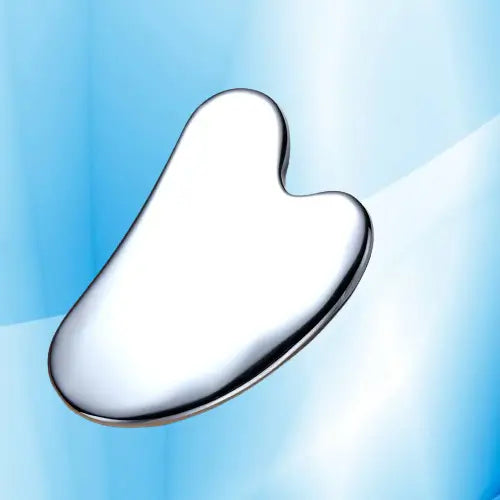 Silver Gua Sha tool on a light blue gradient background