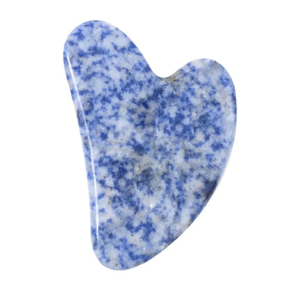 Blue and white speckled gua sha tool on a white background
