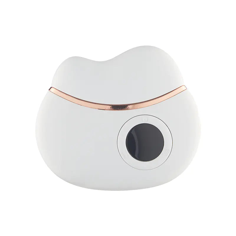 White and rose gold electronic gua sha device on a white background