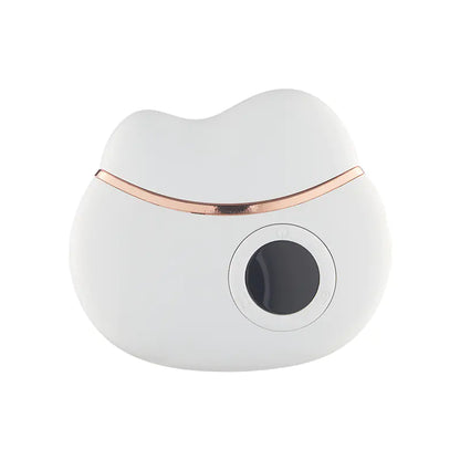White and rose gold electronic gua sha device on a white background