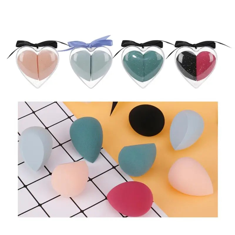 Heart-shaped makeup sponges in various colors with a close-up of different shapes on a grid background.