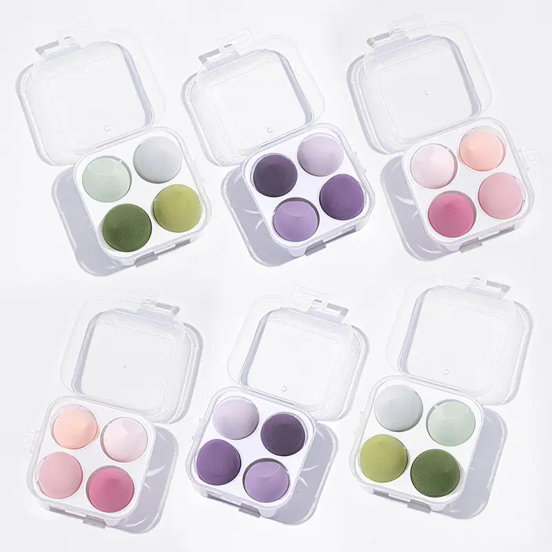 Set of six small makeup palettes with pastel colors on a white background