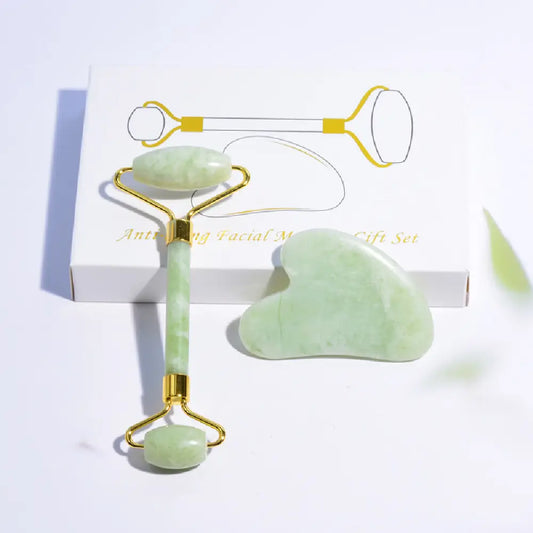 Jade facial roller and gua sha tool set on a white background