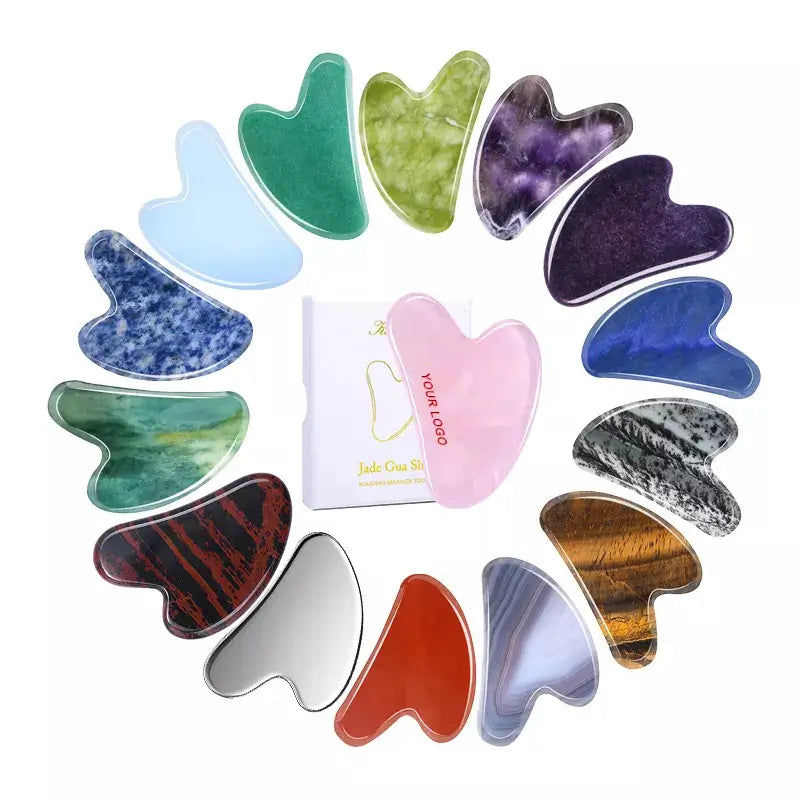 Set of colorful gua sha tools with a white card in the center on a white background