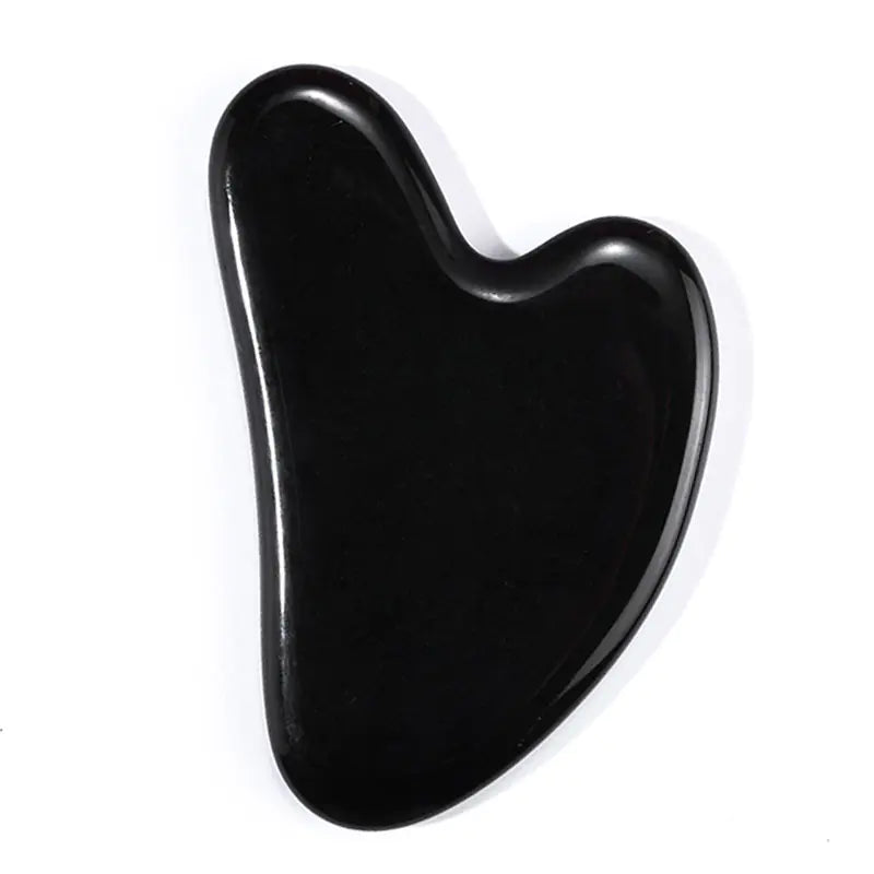 Obsidian gua sha tool on a white background