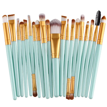 Set of makeup brushes with gold and light blue handles on a white background