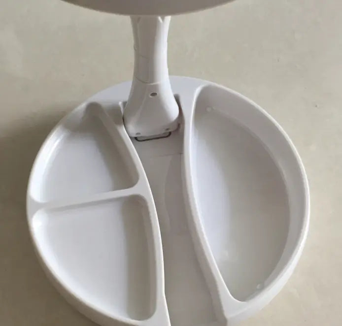 White desk lamp with a divided base on a light gray surface