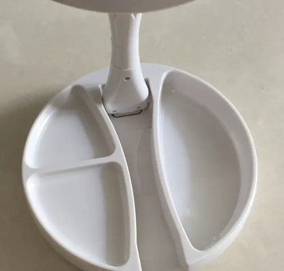White desk lamp with a divided base on a light gray surface