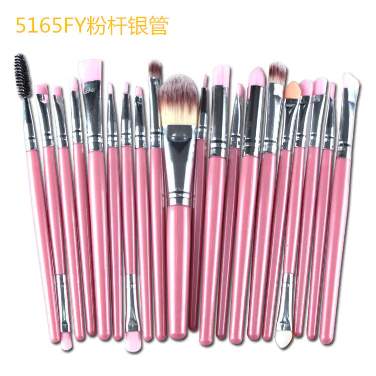 Set of pink makeup brushes with silver ferrules on a white background