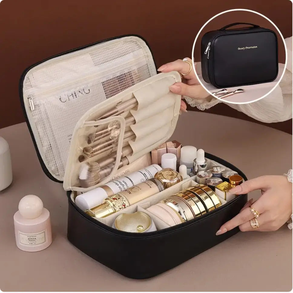 Black cosmetic bag with makeup items and a smaller black bag held by a hand.