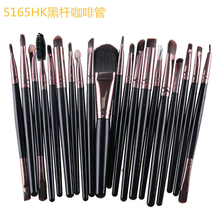 Set of makeup brushes with black handles and rose gold ferrules on a white background.