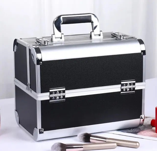 Black and silver makeup case with brushes on a white background