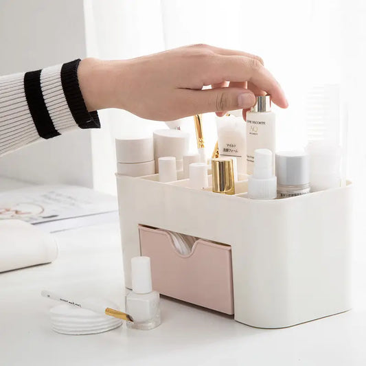 Hand reaching into a white cosmetic organizer filled with skincare products on a light surface.