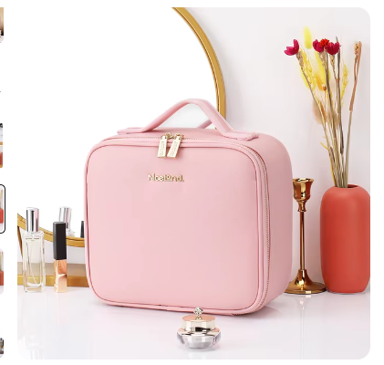 Pink cosmetic bag on a white surface with decorative items.