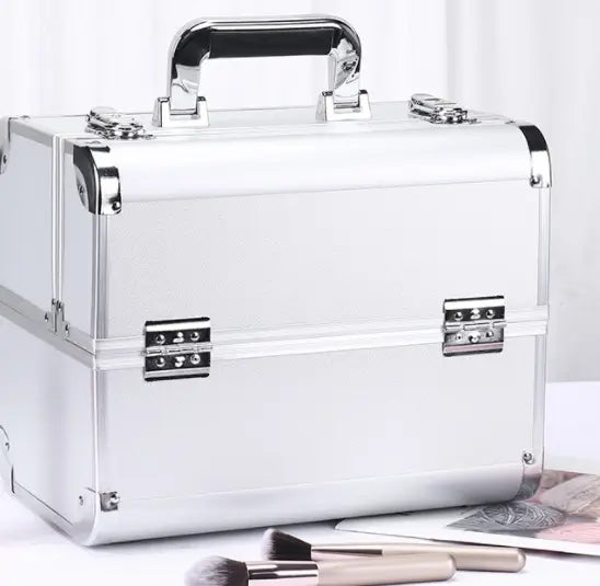 Silver makeup case with brushes on a white background