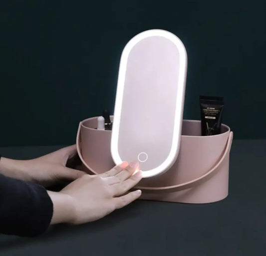 Pink vanity mirror with lighted surface on a dark background