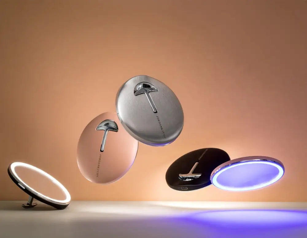 Set of round mirrors with different color lighting on a beige background