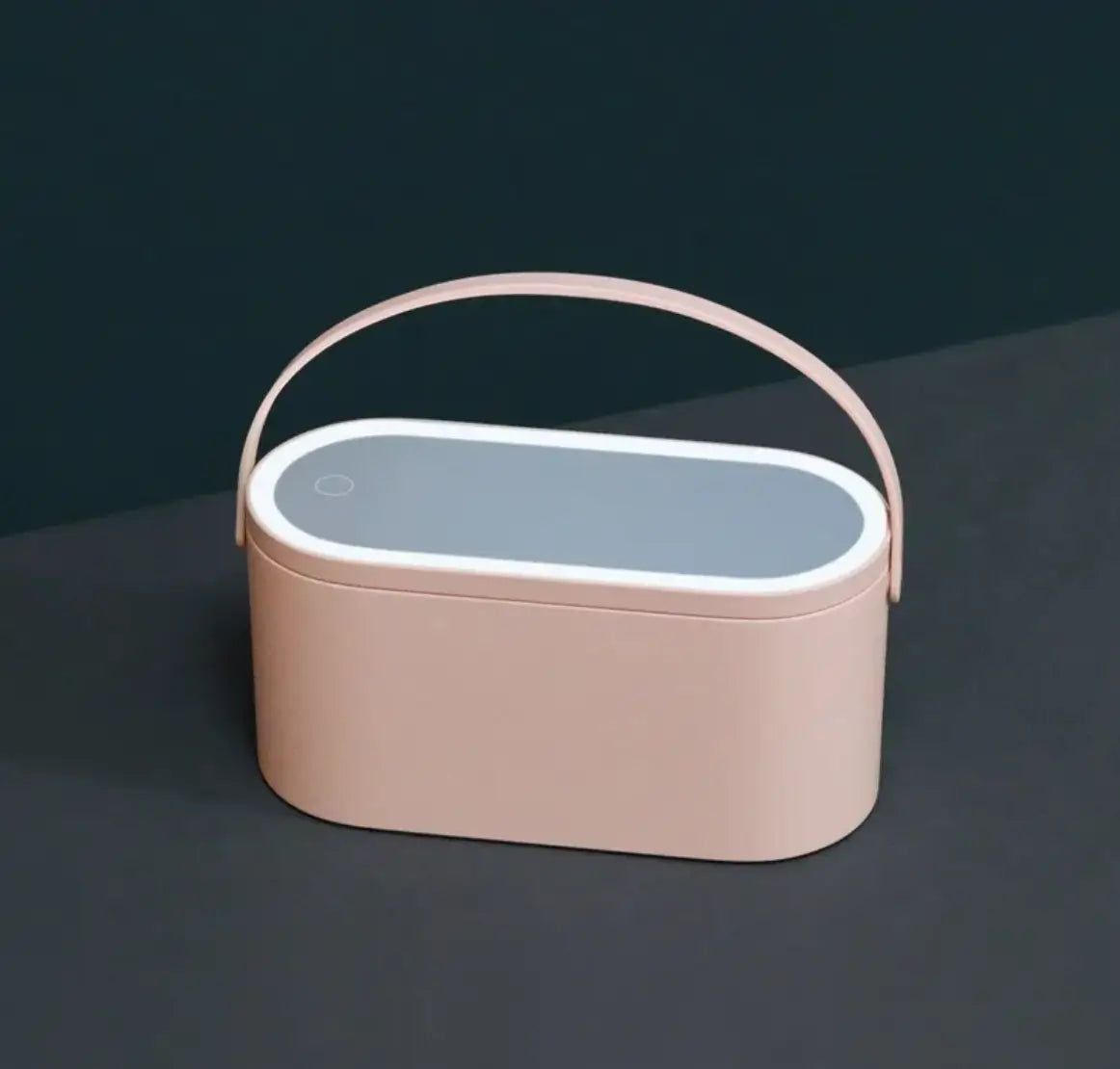 Pink rectangular container with a handle on a dark background