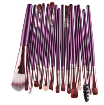 Set of makeup brushes with purple handles on a white background