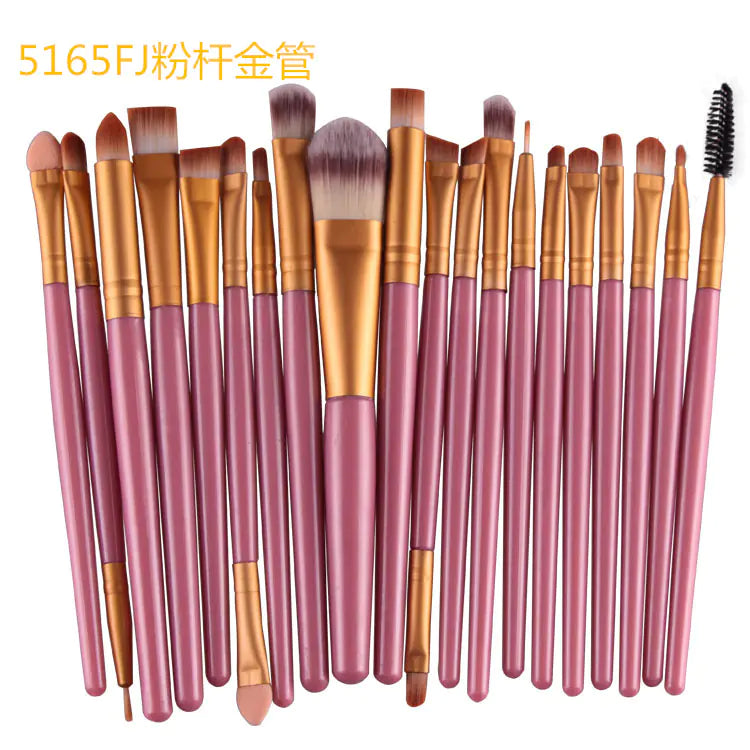 Set of makeup brushes with pink handles and brown bristles on a white background