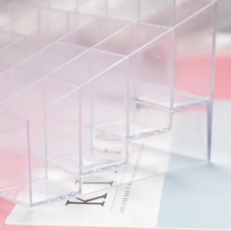 Clear acrylic display stand with a pink and white gradient background