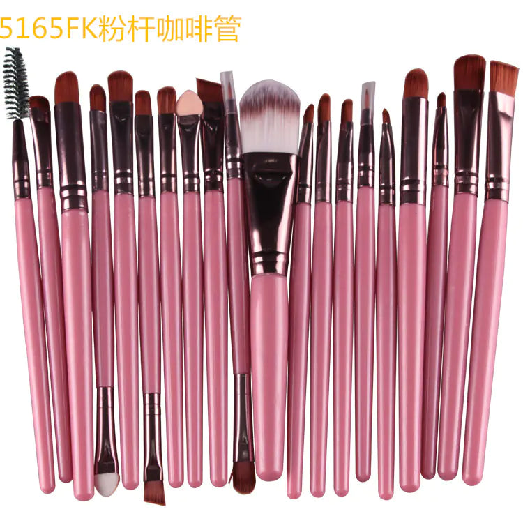 Set of pink makeup brushes with various shapes on a white background
