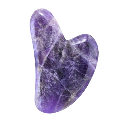 Purple crystal heart-shaped stone on a white background