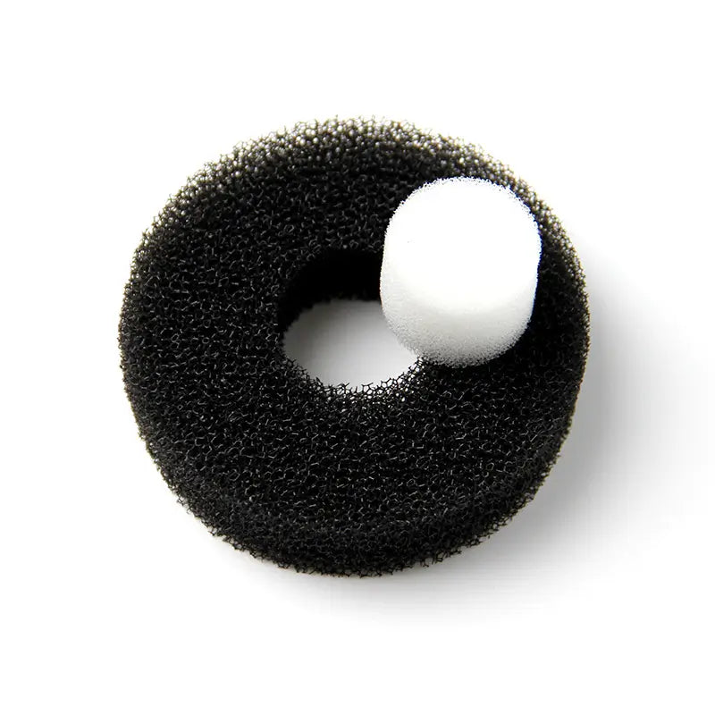 Black foam ring with a white ball on a white background