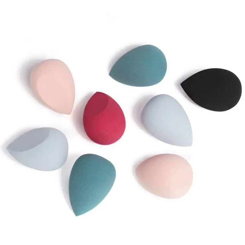 Set of colorful makeup sponges on a white background