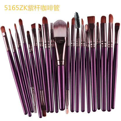 Set of purple makeup brushes with various bristle types on a white background