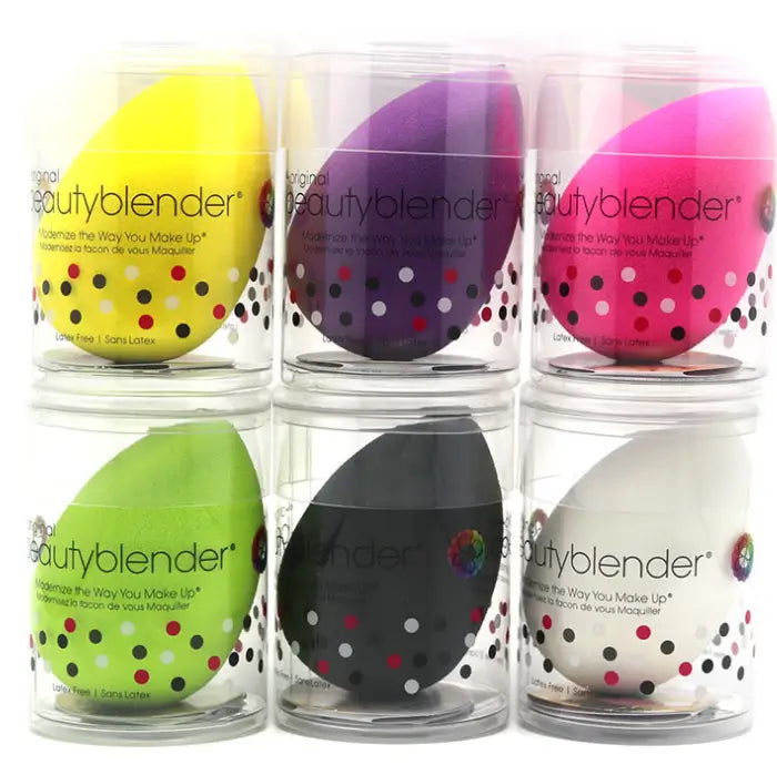 Set of colorful beautyblender applicators in clear containers.