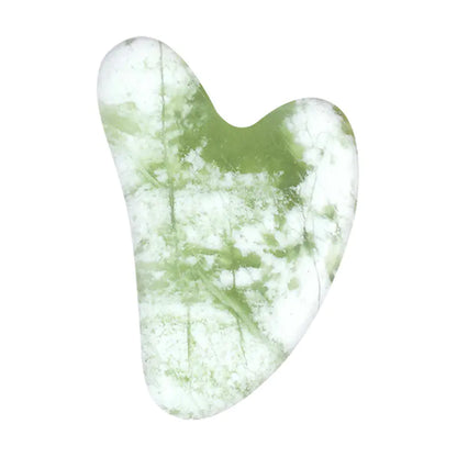 Green and white marbled gua sha tool on a white background