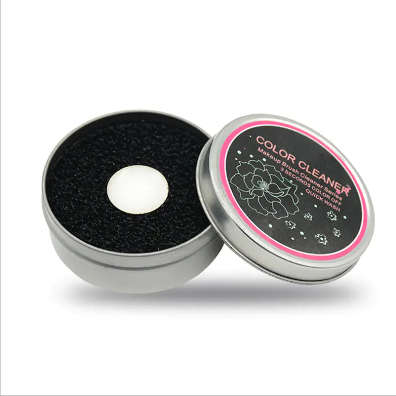Makeup brush cleaner with black sponge and branded lid on a white background