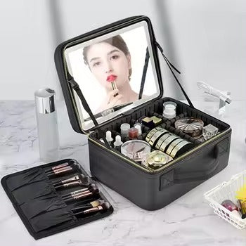 Black makeup case with mirror and cosmetic items on a light gray background