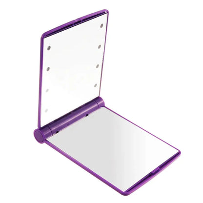 Purple compact mirror with a white interior on a white background