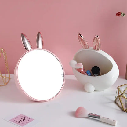 Makeup mirror with bunny ears on a pink background