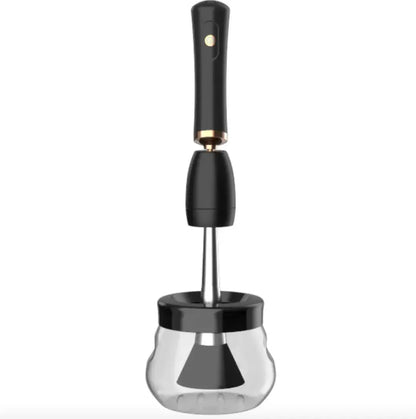 Black makeup brush cleaner on a clear glass container
