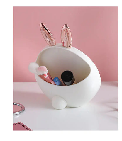 White rabbit-shaped container with pink accents on a pink background