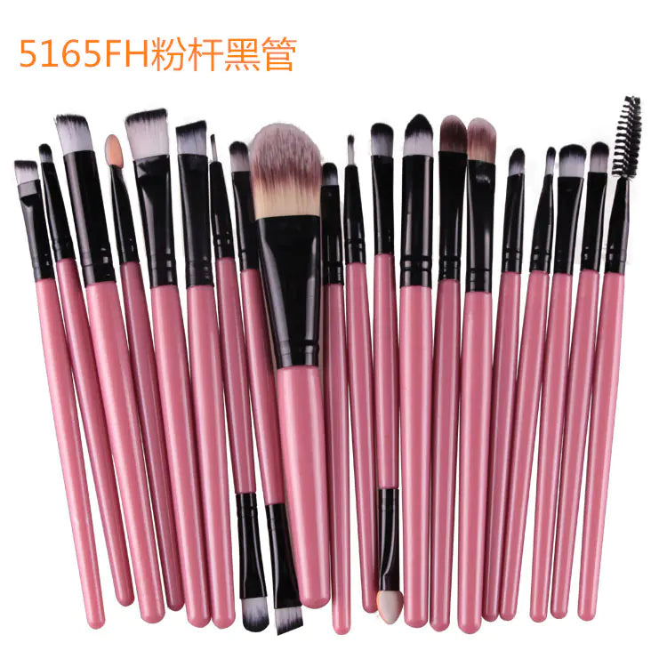 Set of makeup brushes with pink handles and black ferrules on a white background