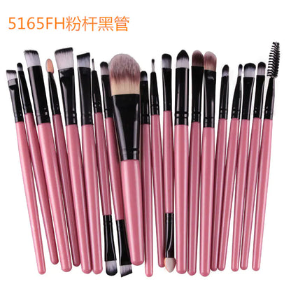 Set of makeup brushes with pink handles and black ferrules on a white background