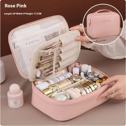 Rose pink cosmetic bag with makeup items on a beige surface