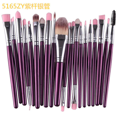 Set of makeup brushes with purple handles on a white background
