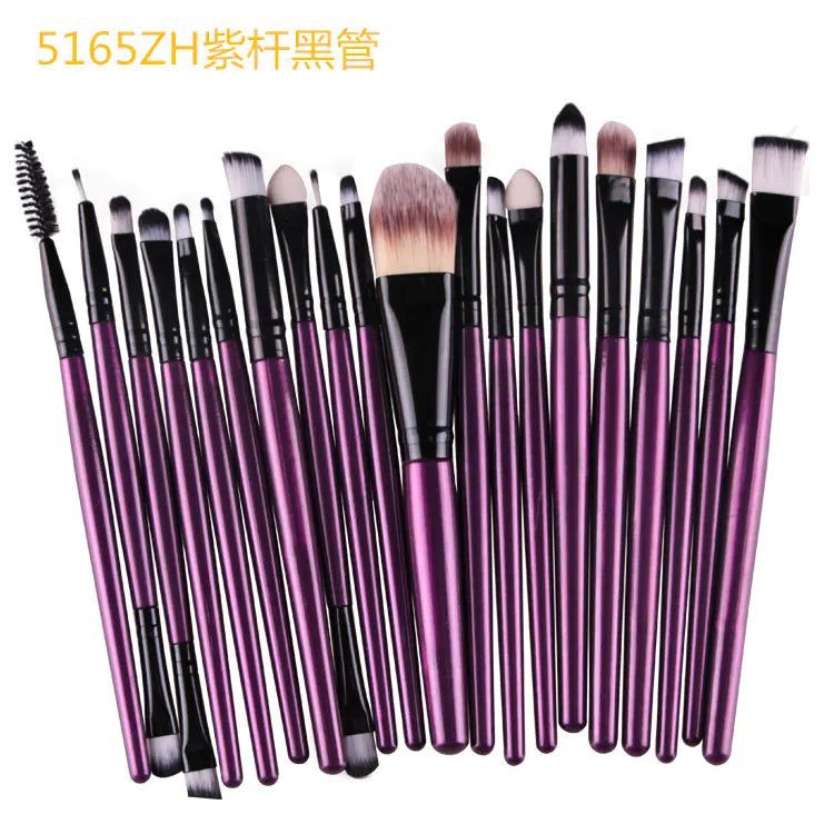 Set of makeup brushes with purple handles on a white background
